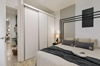 a bedroom with a large bed and a sliding glass door at Espriu - 2 bedrooms and balcony in Sant Antoni in Barcelona