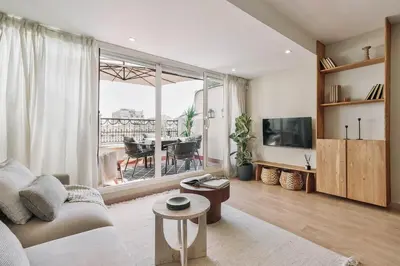a living room with a couch and a table at Ascea - 2 bedroom and terrace in Eixample Esquerra in Barcelona