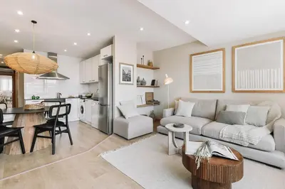 a kitchen and dining room with a washing machine and a table at Ascea - 2 bedroom and terrace in Eixample Esquerra in Barcelona