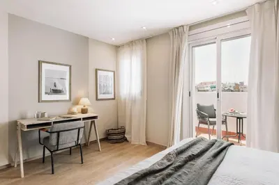 a mirror in a room with a desk and a chair at Ascea - 2 bedroom and terrace in Eixample Esquerra in Barcelona