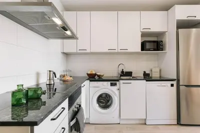 a white bathroom with a sink and a shower at Ascea - 2 bedroom and terrace in Eixample Esquerra in Barcelona