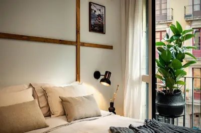 a living room with a couch and a bed at Shokai - 1 bedroom in Ciutat Vella in Barcelona