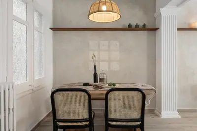 a dining room table with two chairs and a lamp at NIVE - 3 bedrooms apartment in Sant Gervasi in Barcelona