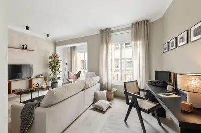 a bedroom with a large bed with two books on it at NIVE - 3 bedrooms apartment in Sant Gervasi in Barcelona
