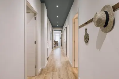 a bedroom with a bed and a dresser and curtains at Giralda - 3 bedrooms in Sagrada Família in Barcelona