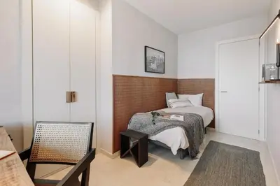 a living room with a couch and a tv at Pavots - 3 bedrooms, pool and gym in Poblenou in Barcelona