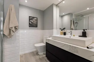 a bedroom with a large bed and a mirror at Newman - 3 bedrooms and terrace in Sant Gervasi in Barcelona