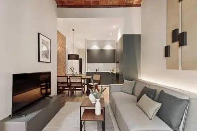 a living room with a couch and a table at Gava - 3 bedrooms and terrace in Sagrada Família in Barcelona