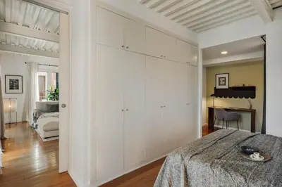a bedroom with a bed and two night stands with lamps at Taksim - 2 bedrooms and balcony in La Barceloneta in Barcelona