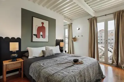a bedroom with a bed and a large window at Taksim - 2 bedrooms and balcony in La Barceloneta in Barcelona