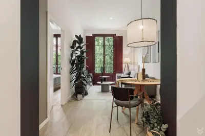 a wooden desk with a lamp and a book at Aire - 1 bedroom and balcony in Sant Antoni in Barcelona