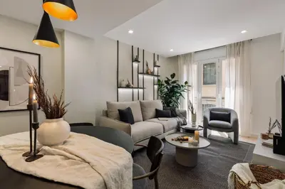 a living room with a couch and a table at Basquiat - 2 bedrooms and office in Sant Gervasi in Barcelona