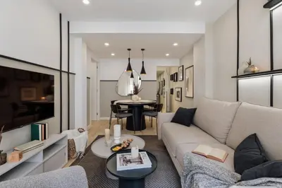 a living room with a desk and a television at Basquiat - 2 bedrooms and office in Sant Gervasi in Barcelona
