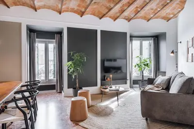 a living room with a couch and a table at Feliu - 2 bedrooms in Eixample Dreta in Barcelona