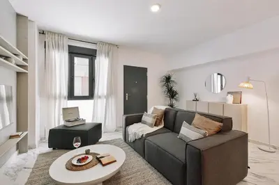 a living room with a couch and a table at Equense - 2 bedrooms in Sant Gervasi in Barcelona