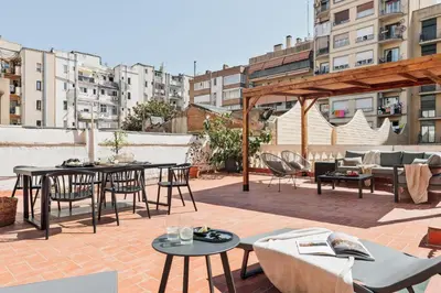 a patio with tables and chairs on a roof at Incahuasi - 3 bedrooms and terrace in Eixample Esquerra in Barcelona