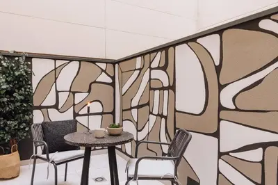 a hallway with white walls and pictures on the walls at Tibi - 2 bedrooms and office in Eixample Esquerra in Barcelona