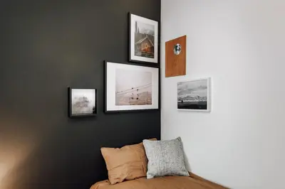 a bedroom with four pictures on the wall at Ziga - 2 bedrooms in Sagrada Família in Barcelona