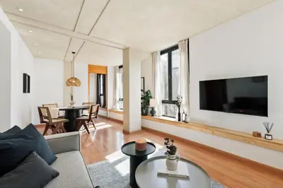 a bedroom with a wooden door leading to a living room at Miro - 1 bedroom in El Born in Barcelona