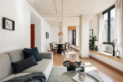a living room with a table and a couch at Miro - 1 bedroom in El Born in Barcelona