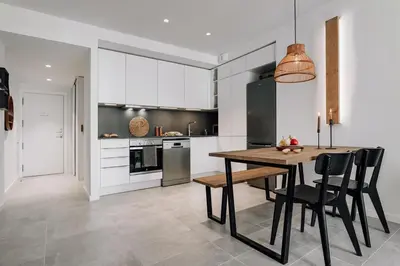 a kitchen with white cabinets and a dishwasher at Olite - 2 bedrooms in Eixample Esquerra in Barcelona