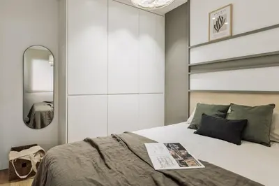 a kitchen with white cabinets and a wooden table at Caliu - 1 bedrooms and terrace in Sagrada Família in Barcelona