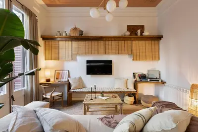 a living room with a table and a couch at Batik - 2 bedrooms and terrace in Eixample Dreta in Barcelona