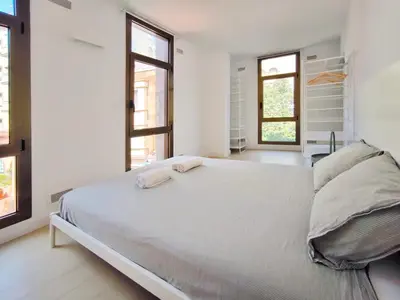 a bedroom with a large bed with two towels on it at Apartamento céntrico, moderno, Terrassa Rambla in Terrassa