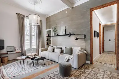 a living room with a couch and a table at Tella - 2 bedrooms and office in Eixample Esquerra in Barcelona