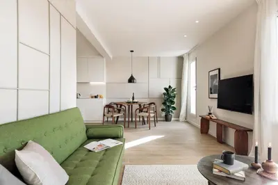 a dining room table with chairs and a black lamp at Calella - 1 bedroom and terrace in Eixample Dreta in Barcelona