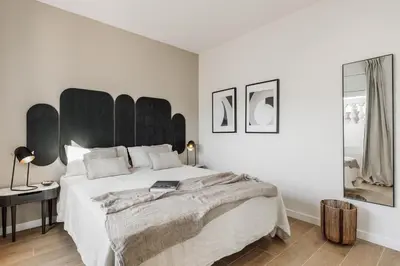 a kitchen with white cabinets and a dining room at Calella - 1 bedroom and terrace in Eixample Dreta in Barcelona