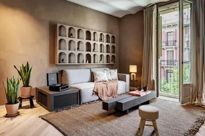a living room with a couch and a tv at Hamid - 2 bedrooms in Eixample Dreta in Barcelona