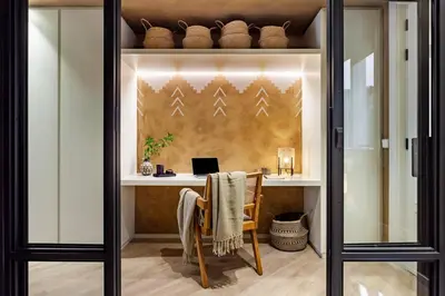 a table with a lamp and framed pictures on the wall at Hamid - 2 bedrooms in Eixample Dreta in Barcelona