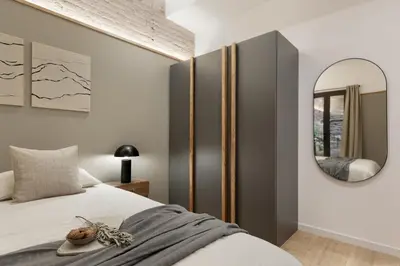 a bedroom with a bed and a mirror at Sazos - 2 bedrooms in Sant Antoni in Barcelona