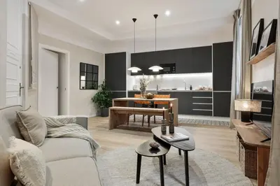 a kitchen with a sink and a table with chairs at Sazos - 2 bedrooms in Sant Antoni in Barcelona