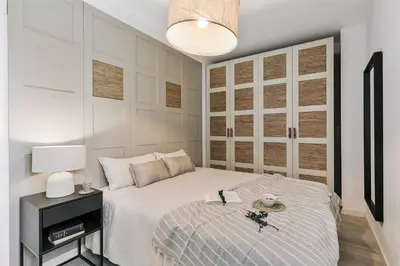 a kitchen with a wooden table and a lamp at Minori - 2 bedrooms and pool in Poblenou in Barcelona