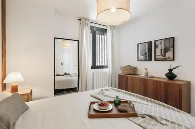 a bedroom with a bed with a stuffed duck on it at Minori - 2 bedrooms and pool in Poblenou in Barcelona
