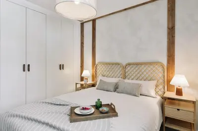 a bed with a tray of food on it at Minori - 2 bedrooms and pool in Poblenou in Barcelona