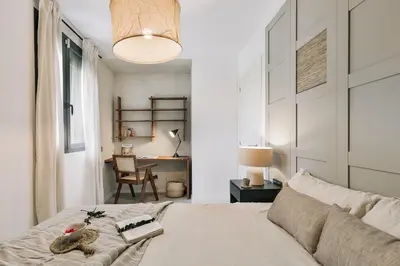 a kitchen with a wooden table and chairs in a room at Minori - 2 bedrooms and pool in Poblenou in Barcelona