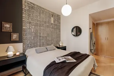 a bed with a tray of food on top of it at Etosha - 3 bedrooms and balcony in Eixample Dreta in Barcelona