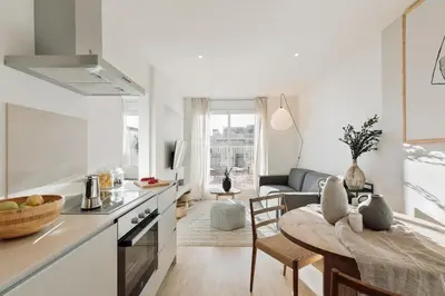 a living room with a wooden table with vases on it at Spiaggia - 1 bedroom and terrace in Sant Gervasi in Barcelona