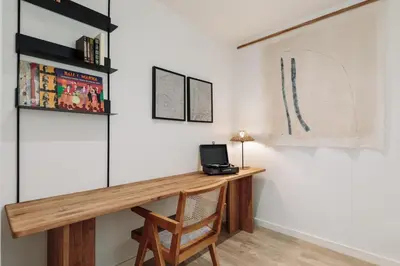 a living room with a table and a couch at Spiaggia - 1 bedroom and terrace in Sant Gervasi in Barcelona