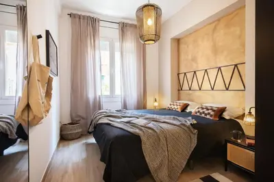 a dining room with a table and chairs and a mirror at Adigrat - 3 bedrooms in Gràcia in Barcelona