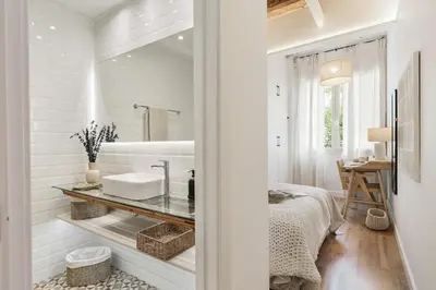 a white hallway with a mirror and a bedroom at Scala - 2 bedrooms in Sant Gervasi in Barcelona