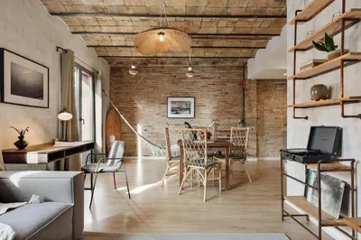 a living room with a table and chairs and a couch at Kuta - 2 bedrooms and balcony in Sant Gervasi in Barcelona