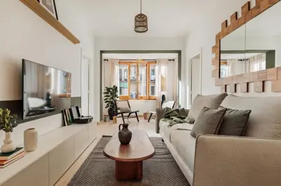 a living room with a couch and a tv at Demir - 2 bedrooms and office in Vila de Gràcia in Barcelona