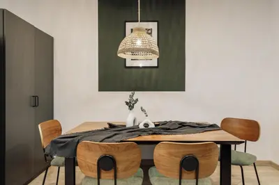 a living room with a couch with a mirror on the wall at Demir - 2 bedrooms and office in Vila de Gràcia in Barcelona