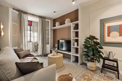 a living room with a couch and a tv at Aksaray - 2 bedrooms in Eixample Esquerra in Barcelona