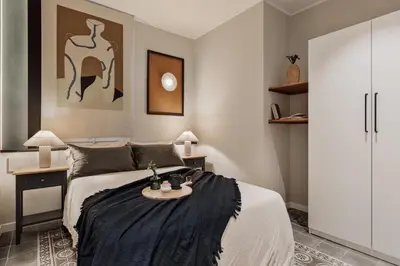a living room with a couch and a tv at Aksaray - 2 bedrooms in Eixample Esquerra in Barcelona