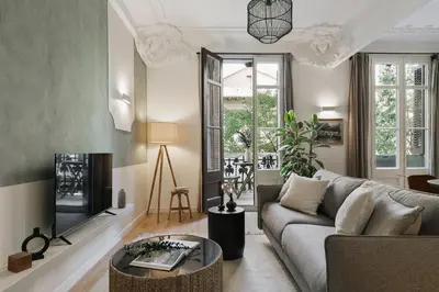 a living room with a couch and a fireplace at Paestum - Studio and balcony in Eixample Esquerra in Barcelona